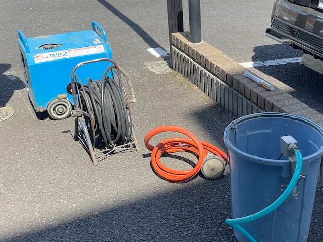 業務用のエンジン式高圧洗浄機と溜め水バケツ